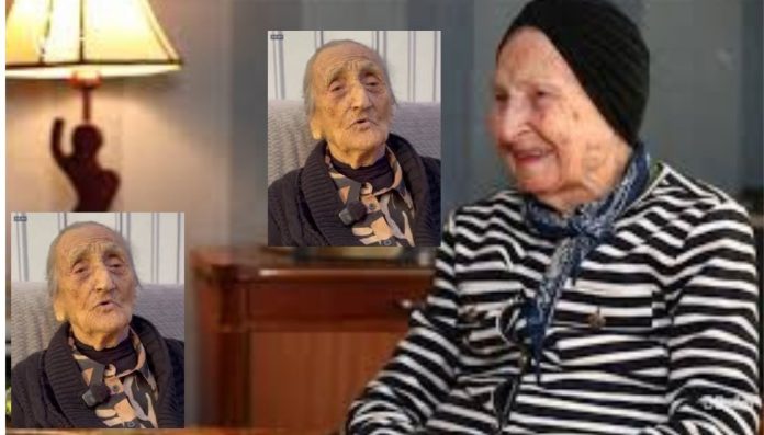 Collage of an elderly woman smiling, wearing a black-and-white striped top and head scarf, with two smaller portraits of her in different outfits nearby.